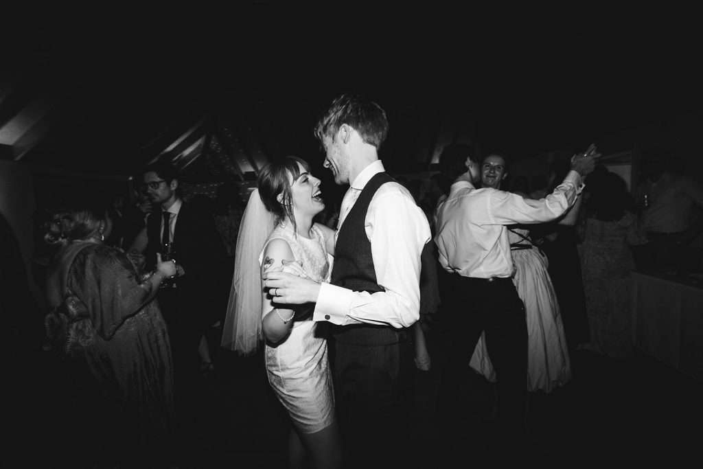 Bride and groom sharing their first dance at The Glass House Hackney, with guests watching.